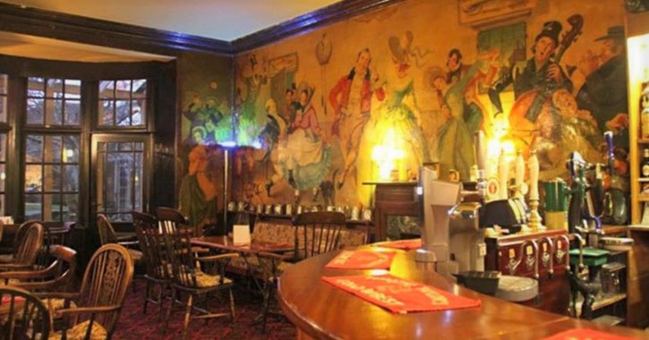 view of Dickens Bar and Bistro seating area with colourful mural on the wall, inside The Morritt Hotel, Barnard Castle
